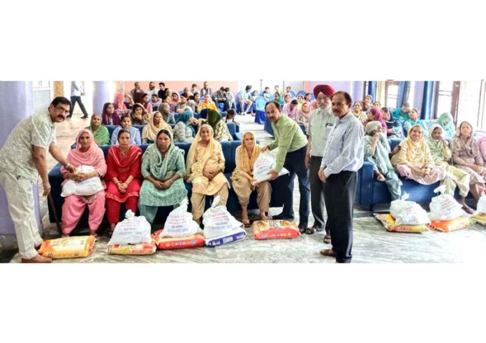 Members of Vridh Ashram distributing ration among aged and infirm people in Jammu.