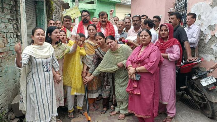 MLA Arvind Gupta with residents inaugurating development works in Shakti Nagar.