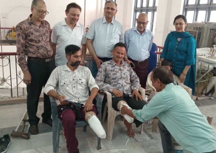People getting free artificial limbs at a camp.