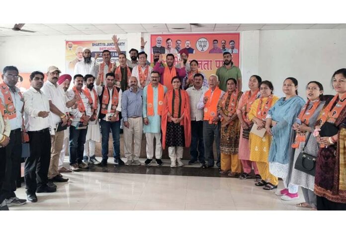 BJP leader Sanjay Baru with party workers in Kathua.