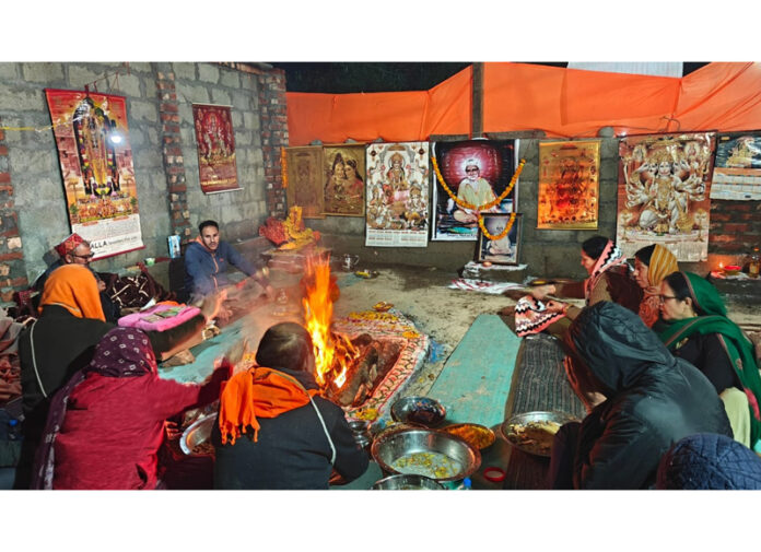 Devotees performing Pooja at Samadhi of Swami Mirzakak at village Hangalgund, Anantnag on Sunday.