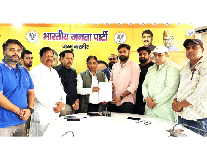 Sat Sharma being handed over a memorandum by a delegation of unemployed youth at party office in Trikuta Nagar on Monday.