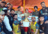 Winning team alongwith dignitaries posing with the trophy during a programme —Excelsior/Tilak Raj