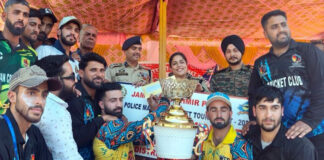 Winning team alongwith dignitaries posing with the trophy during a programme —Excelsior/Tilak Raj