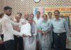 Members of Tawi Welfare Society distributing ration kits among beneficiaries.