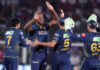 Gujarat Titans player celebrating with teammates after taking a wicket against RR in Jaipur on Saturday.