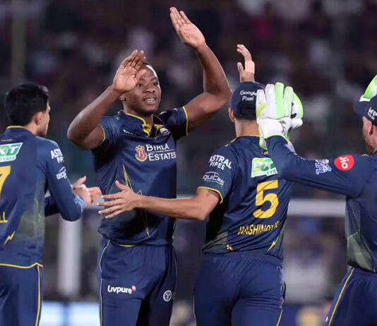 Gujarat Titans player celebrating with teammates after taking a wicket against RR in Jaipur on Saturday.