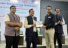 An officer being presented with a certificate during a training programme at Gujarat National Law University.