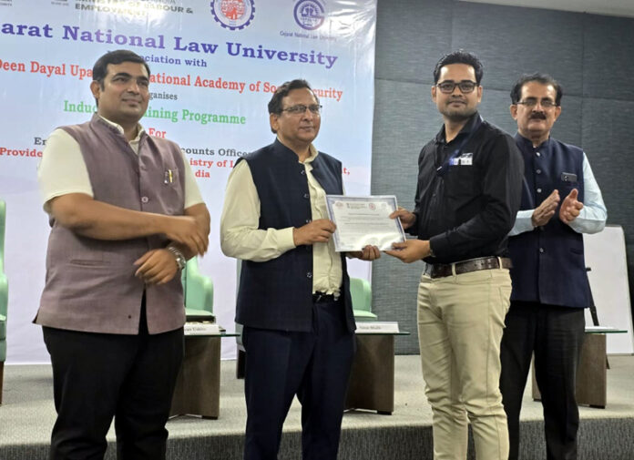 An officer being presented with a certificate during a training programme at Gujarat National Law University.