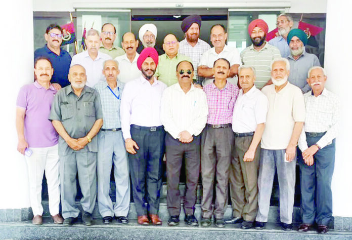 Retired police personnel posing for a group photograph during their monthly meeting in Jammu on Tuesday.
