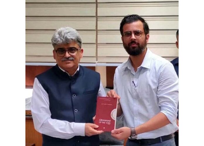 Satyarth Pandita, the author of book ‘Grammar of the Void’ presenting his book to Chief Secretary, Atal Dulloo at Civil Secretariat Jammu on Thursday.