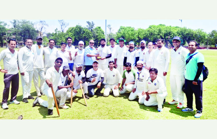 Winning team posing with trophy during the closing ceremony.