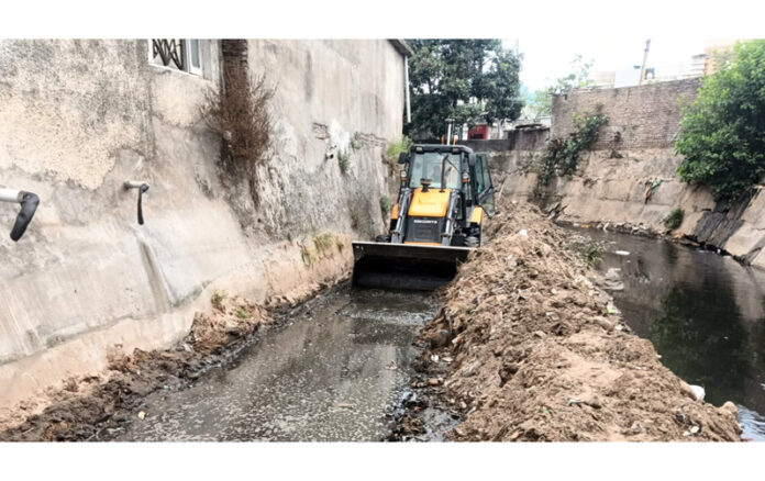 JMC machinery clearing silt from a Nallah in Nanak Nagar area of Jammu.