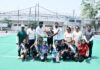 Dignitaries presenting trophy to winning team during a programme.