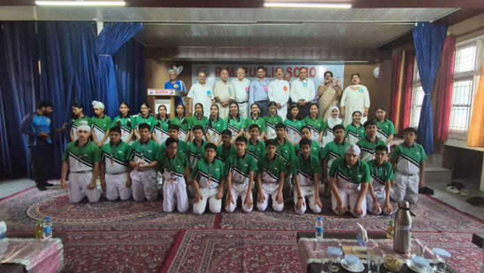 Students along with dignitaries posing for a group photograph during a programme. Students along with dignitaries posing for a group photograph during a programme.