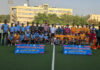 Hockey players posing along with dignitaries during a programme.