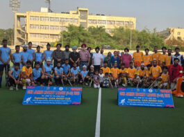 Hockey players posing along with dignitaries during a programme.