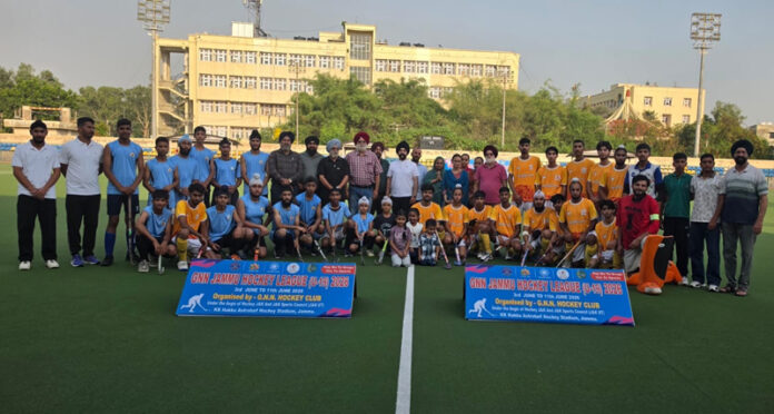 Hockey players posing along with dignitaries during a programme. Hockey players posing along with dignitaries during a programme.