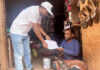 Dinabandhu Boral, Head of Project (HoP), Sawalkote HE Project presenting a cap to a person in Ramban.