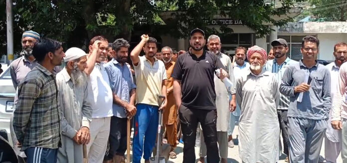 People staging protest against Irrigation Dept for not repairing damaged canal at Darhal. -Excelsior/ Imran