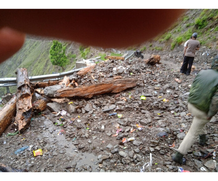 Debris cover road in Sarthal, Kishtwar after flash floods triggered by heavy rains hit the area on Tuesday. -Excelsior/Ajay Shan Debris cover road in Sarthal, Kishtwar after flash floods triggered by heavy rains hit the area on Tuesday. -Excelsior/Ajay Shan
