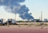 Smoke rises as Iran fires ballistic missiles toward Kuwait.