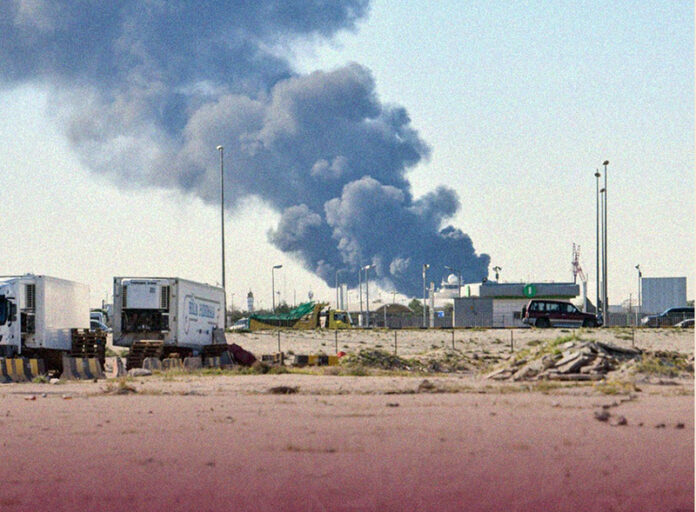 Smoke rises as Iran fires ballistic missiles toward Kuwait.