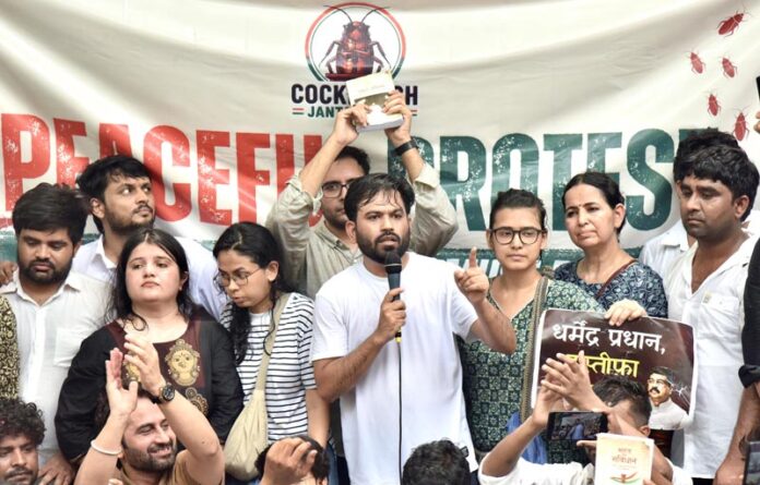 Cockroach Janta Party's founder Abhijeet Dipke addressing supporters during a protest demanding the resignation of Union Education Minister Dharmendra Pradhan at the Jantar Mantar, in New Delhi on Saturday. (UNI) Cockroach Janta Party's founder Abhijeet Dipke addressing supporters during a protest demanding the resignation of Union Education Minister Dharmendra Pradhan at the Jantar Mantar, in New Delhi on Saturday. (UNI)