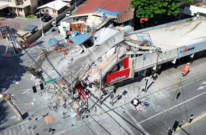 A drone view shows a collapsed building after a magnitude 7.8 quake in General Santos, Mindanao Island, Philippines. A drone view shows a collapsed building after a magnitude 7.8 quake in General Santos, Mindanao Island, Philippines.