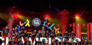 Chase master Kohli, accurate bowlers propel RCB to second IPL title in a row RCB players posing with the IPL trophy.