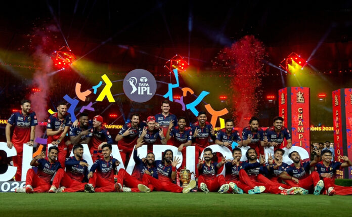 RCB players posing with the IPL trophy. RCB players posing with the IPL trophy.