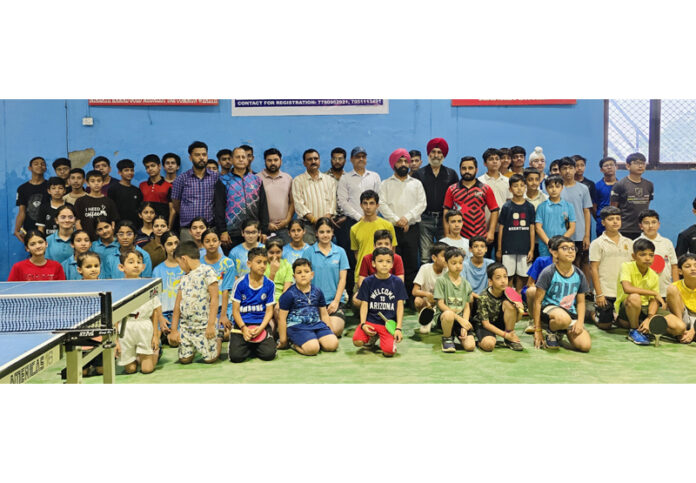 Table Tennis players posing along with dignitaries.