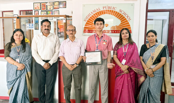 Amaay Gupta posing along with school management during a programme.
