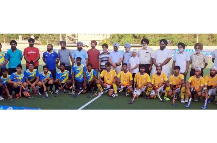 Hockey players posing along with dignitaries during a programme. Hockey players posing along with dignitaries during a programme.