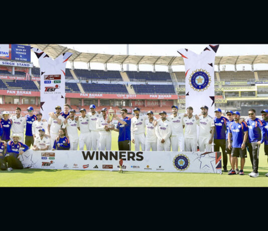 Team India Manager Rajesh Dhar from Jammu and Kashmir posing for a group photograph with players along with the trophy during the post-match presentation ceremony.