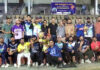 Winning team posing along with trophy.