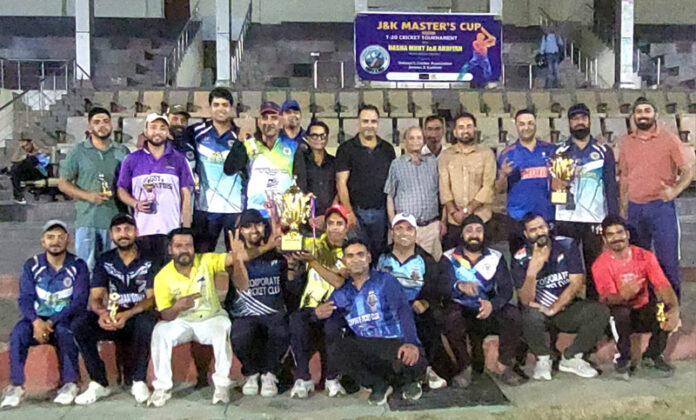 Winning team posing along with trophy.