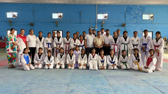 Athletes posing along with dignitaries during a programme.