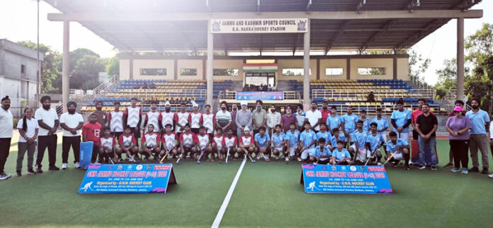 Hockey players posing along with dignitaries during the match. Hockey players posing along with dignitaries during the match.