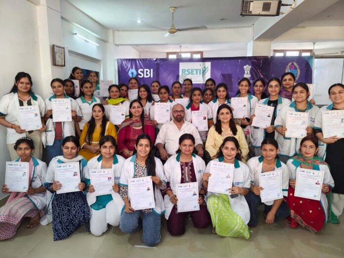 Candidates who completed the Junior Beauty Practitioner training by SBI-RSETI Jammu along with others posing for a photograph.