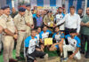 Dignitary presenting trophy to winners during closing ceremony.