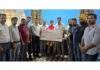 College management presenting cheque to boxer Mohd Yasser during a programme.
