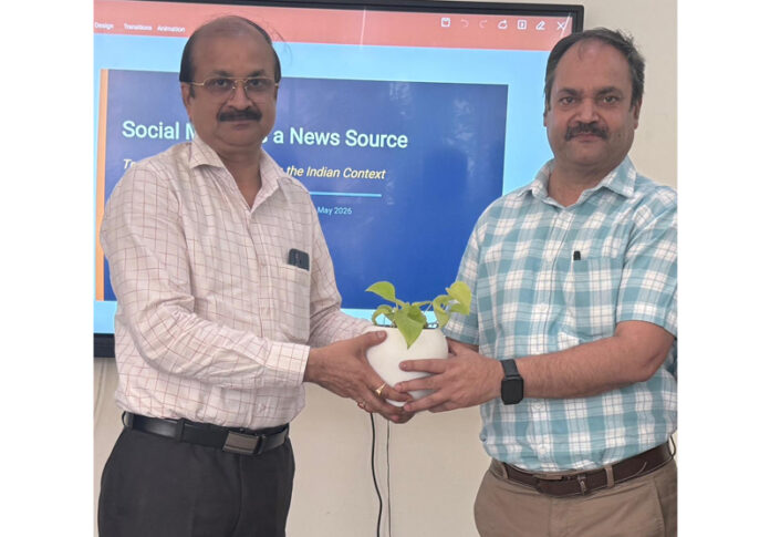 HoD Journalism, Prof Dushyant Rai presenting a plant sapling memento to Nishikant Khajuria. HoD Journalism, Prof Dushyant Rai presenting a plant sapling memento to Nishikant Khajuria.